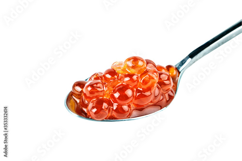 Red caviar in the silver spoon. Isolated object on white background. Close up.