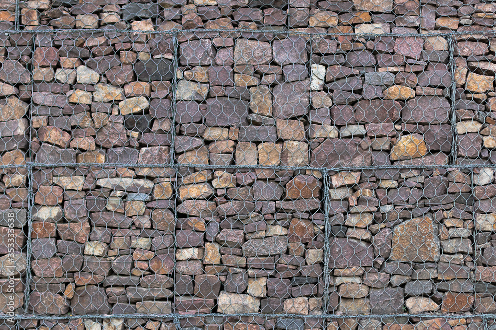 Obraz premium stone wall behind a metal grid