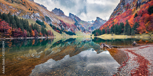 Panoramic morning view of Seealpsee lake. Colorful autumn scene of Swiss Alps. Majestic Santis peak reflected in the calm surface of pure water lake. Beauty of nature concept background, Switzerland
