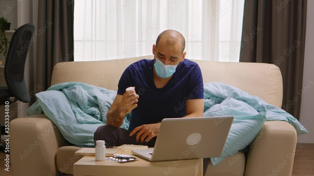 Man with protective mask during covid-19 in a video call on laptop talking with the doctor about his medicine. Man with protective mask during covid-19 in a video call on laptop talking with the doctor about his medicine.
