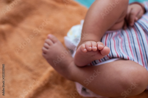 Crossed legs of a small baby wearing diaper © Tejjas