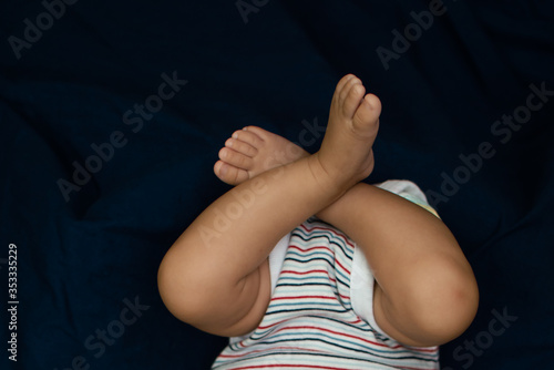 Legs on an infant on blue background © Tejjas