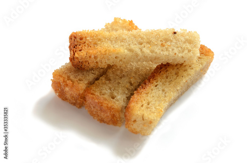 Several rusks in the form of straws. On a white background with selective focus.