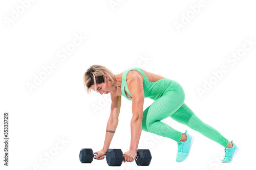 Fit sexy woman doing plank exercise on dumbbells isolated over white background.