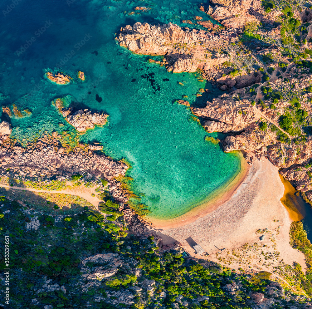 Top down view of Li Cossi beach. Splendid summer scene of Costa Paradiso, Sardinia island, Italy, Europe. Attractive Mediterranean seascape. Beauty of nature concept background.