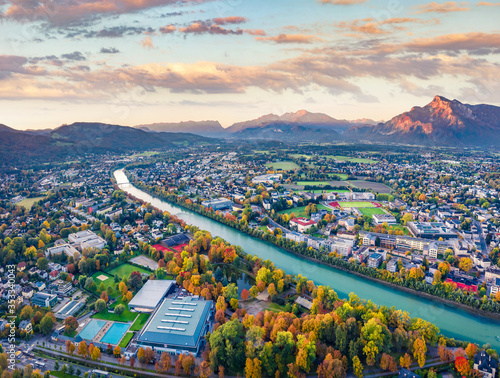 View from flying drone. Magnificent morning cityscape of Salzburg, Old City. Fantastic autumn sunrise on Eastern Alps. Aerial landscape with Salzach river. Traveling concept background.