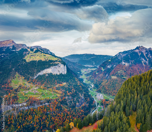 View from flying drone of Gsteigwiler village. Amazing morning scene of Swiss Alps. Impressive autumn landscape of Switzerland, Europe. Traveling concept background. photo