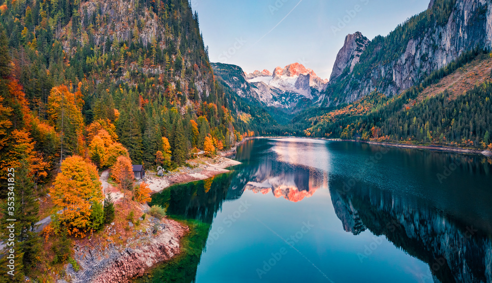 View from flying drone. Captivating autumn view of Gosausee (Vorderer) lake with Dachstein glacieron background. Spectacular evening scene of Austrian Alps, Upper Austria, Europe.