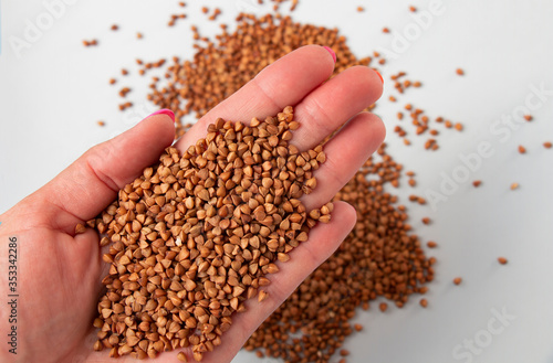 buckwheat groats on a woman's lodoni, top view. Gluten-free and healthy diet. I love buckwheat concept. © Inga