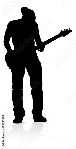 A guitarist musician in detailed silhouette playing his guitar musical instrument.