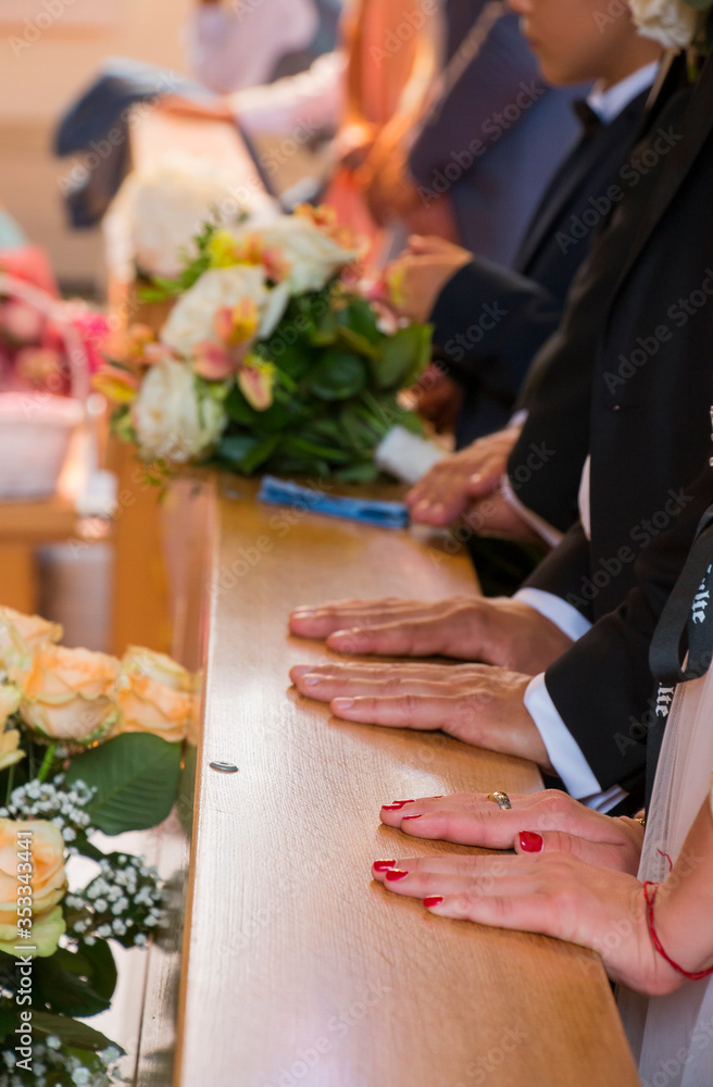 Religious people praying to God in a church at a wedding ceremony Religious people praying to God in a church at a wedding ceremony