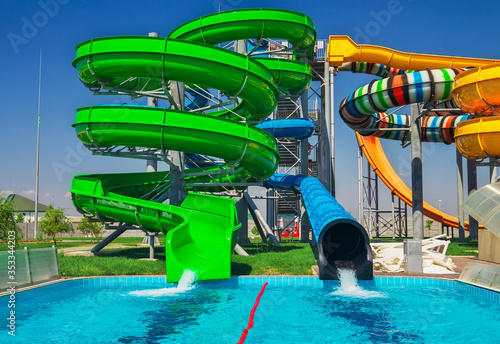 Colorful aquapark slide with pool for everyone. Happy holidays on vacation