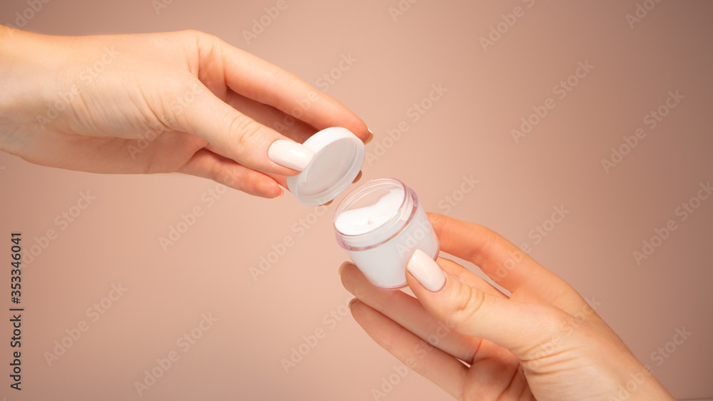 Beautiful hands hold a jar of cream. Beautiful hands hold a jar of cream.