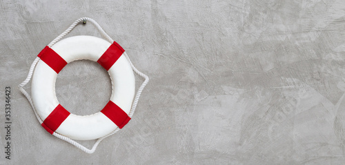 Lifebuoy on concrete wall background. photo