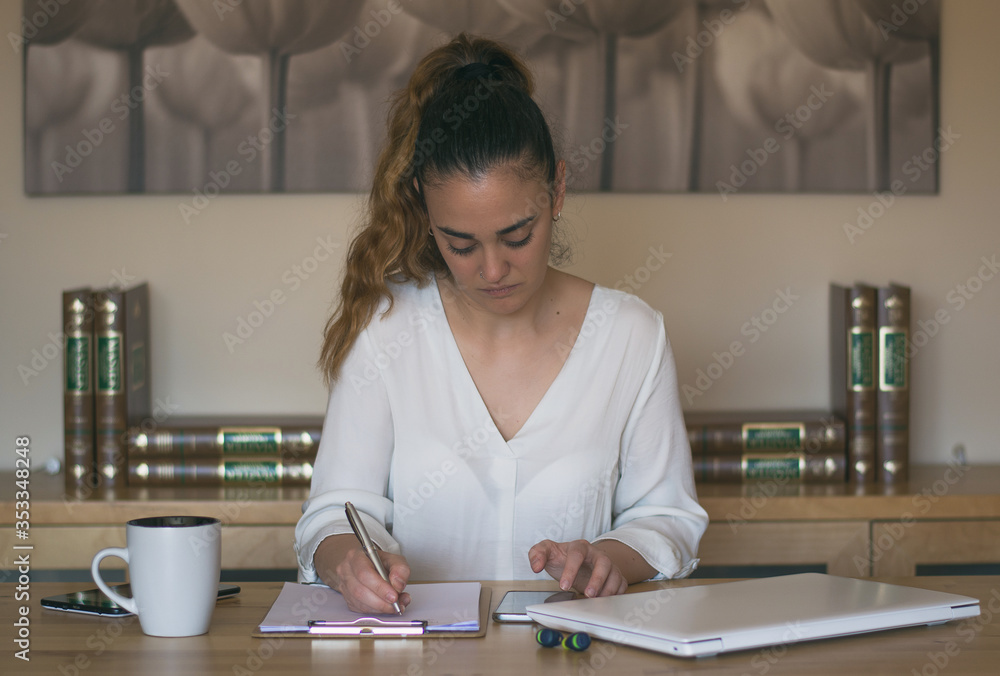 Woman having a cup of coffee while working from home. Teleworking. Covid 19 Woman having a cup of coffee while working from home. Teleworking. Covid 19