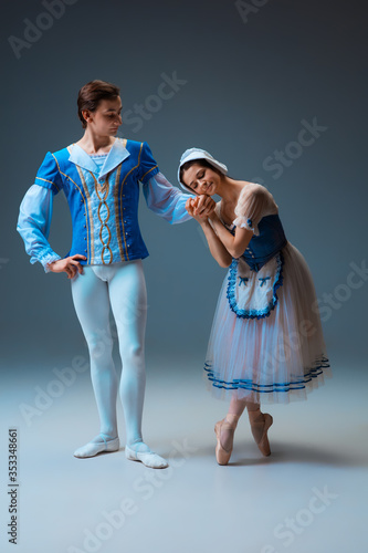 Φωτογραφία Young and graceful ballet dancers as Cindrella fairytail characters on studio background