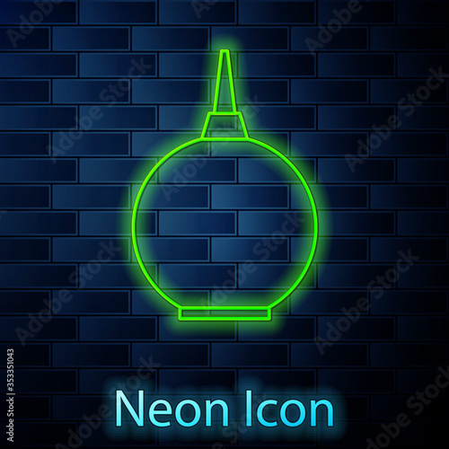 Glowing neon line Enema icon isolated on brick wall background. Enema with a plastic tip. Medical pear. Vector Illustration