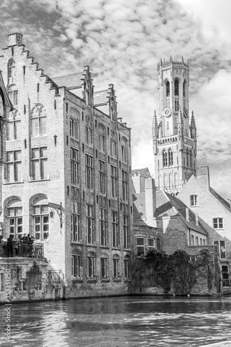 Bruges, Belgium - March 27, 2015 - view of the canal, old houses and the cathedral in the historic city center. Black and white photography