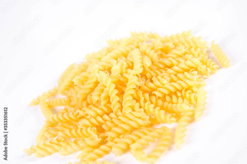 Raw fusilli pasta on a white background Raw fusilli pasta on a white background