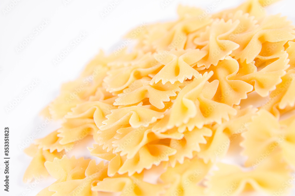 Raw Farfalle pasta on a white background Raw Farfalle pasta on a white background