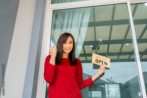 Woman opening store with sign board front door shop for service customer, Small business turning agian after the situation is resolved. photo