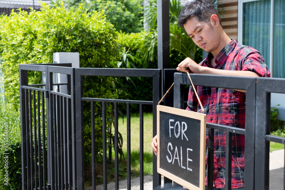 Unemployment worker male for sale house sign effect of money less income, stressed job when the coronavirus crisis covid19 bankruptcy failure. Unemployment worker male for sale house sign effect of money less income, stressed job when the coronavirus crisis covid19 bankruptcy failure.