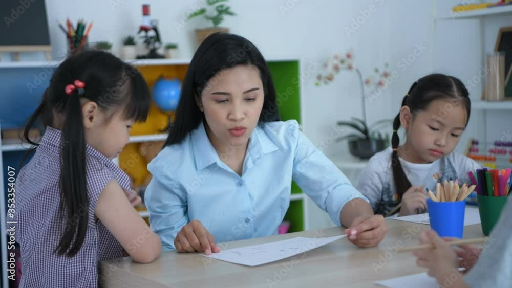 Educational concept. The teacher is talking to the children in the classroom. 4k Resolution. Educational concept. The teacher is talking to the children in the classroom. 4k Resolution.