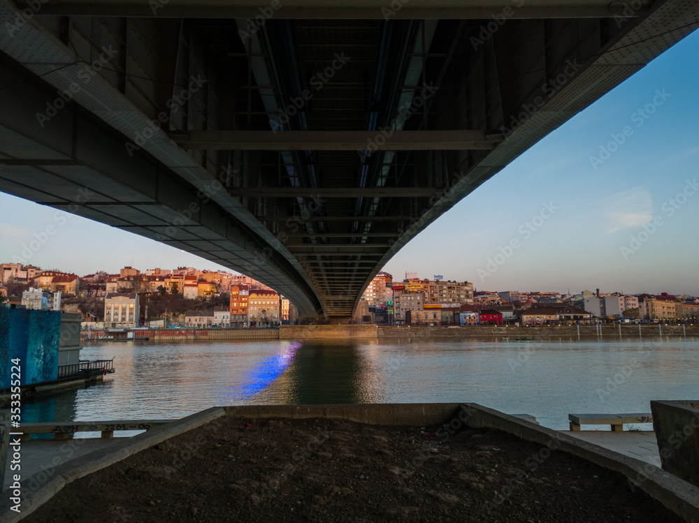 Cityscape of Belgrade under the Branko's bridge at twilight.