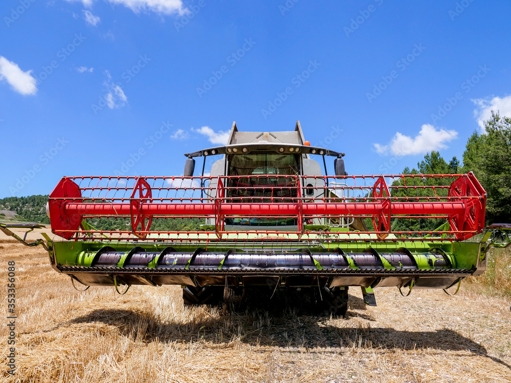 Fototapeta premium Combine harvester parked in a large Wheat field.