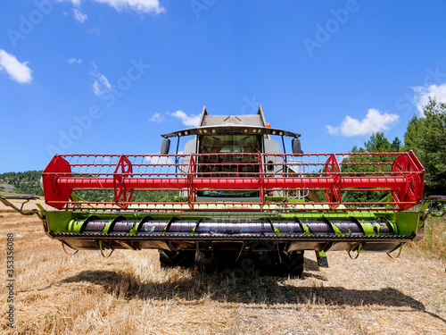 Combine harvester parked in a large Wheat field.