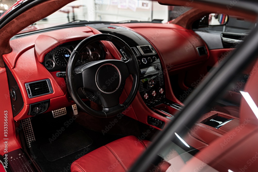 Red leather seats in car. Modern luxury sport car interior.