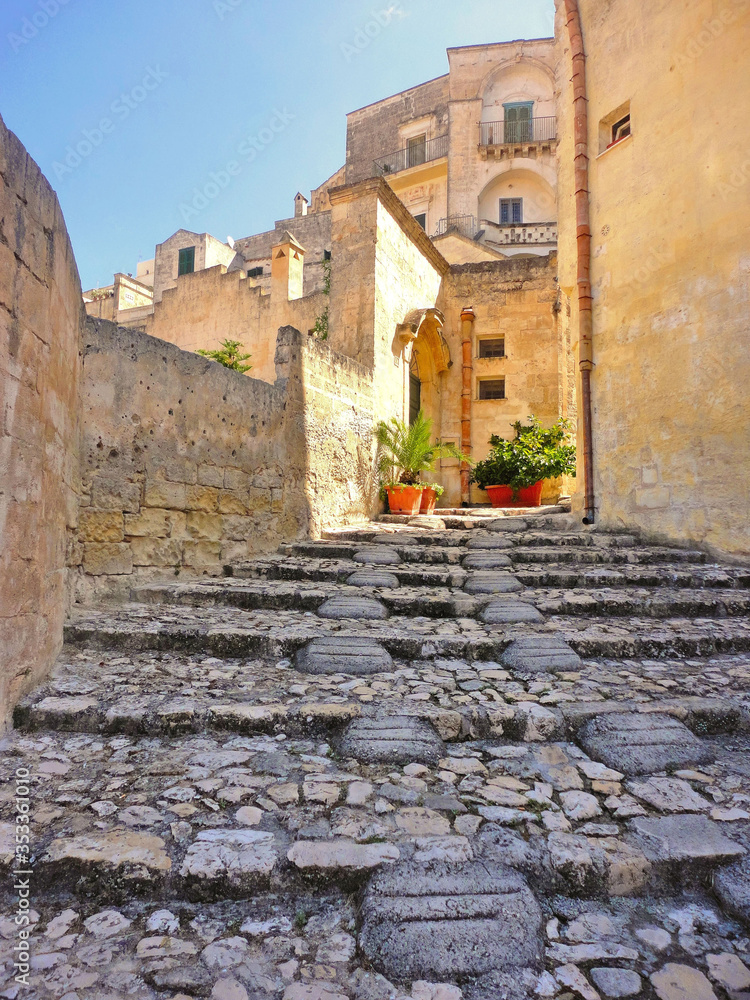old narrow medieval street and picturesque stone houses in historical city of Matera, Basilicata Italy     