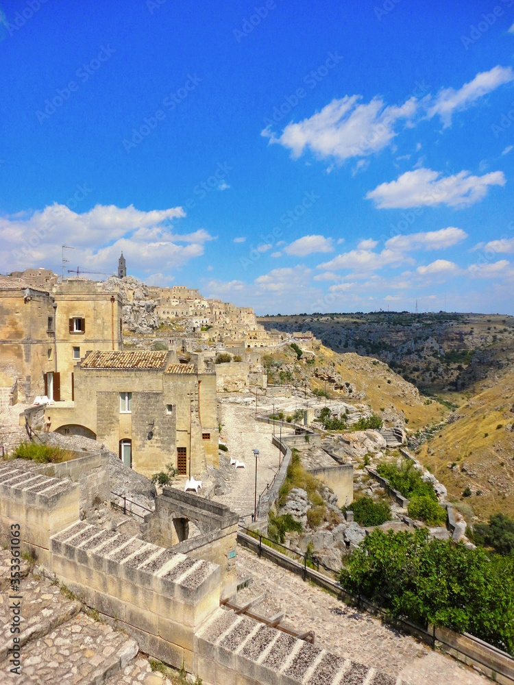 Panoramic view of the ancient town of Matera (Sassi di Matera), European Capital of Culture 2019,and UNESCO Heritage  site  with blue sky and clouds, Basilicata, southern Italy  