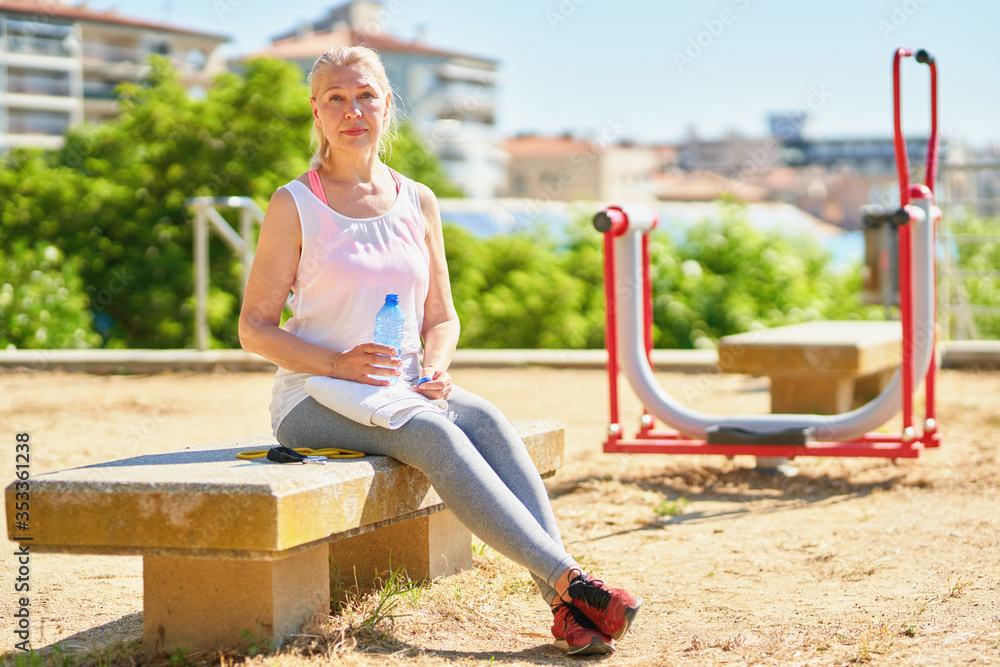 Adult senior sports woman doing exercises outdoors