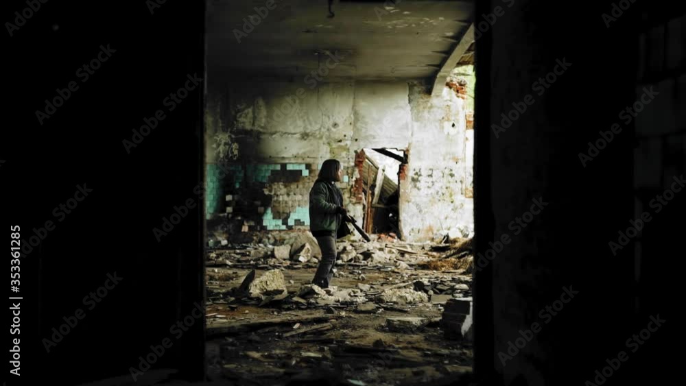 A guy with a baseball bat in a ruined building looks around. Cinematic ...