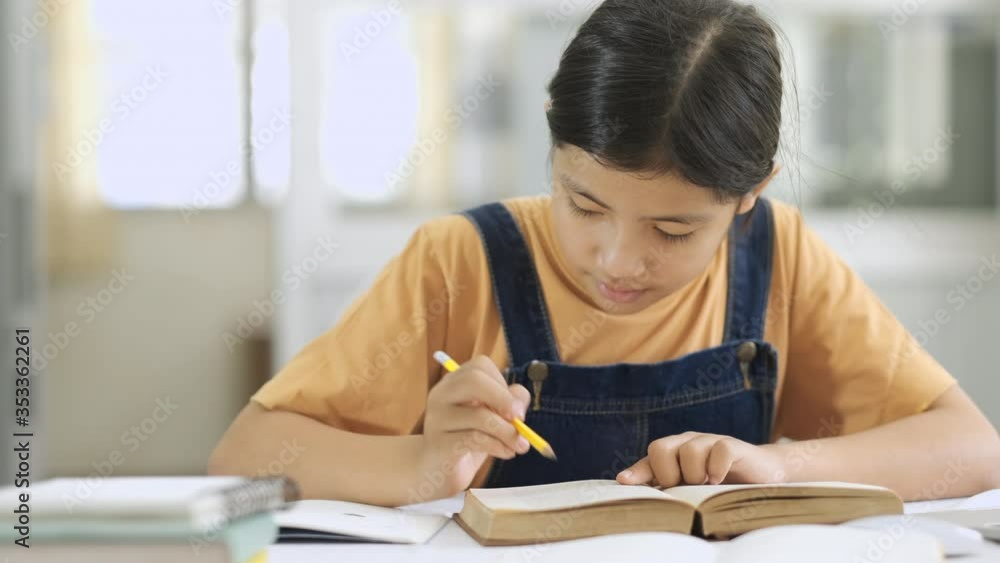 Girl Doing Homework at Home Table. Close up shot. Girl Doing Homework at Home Table. Close up shot.