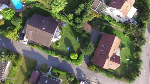 Drone circles over a green residential area in Switzerland photo