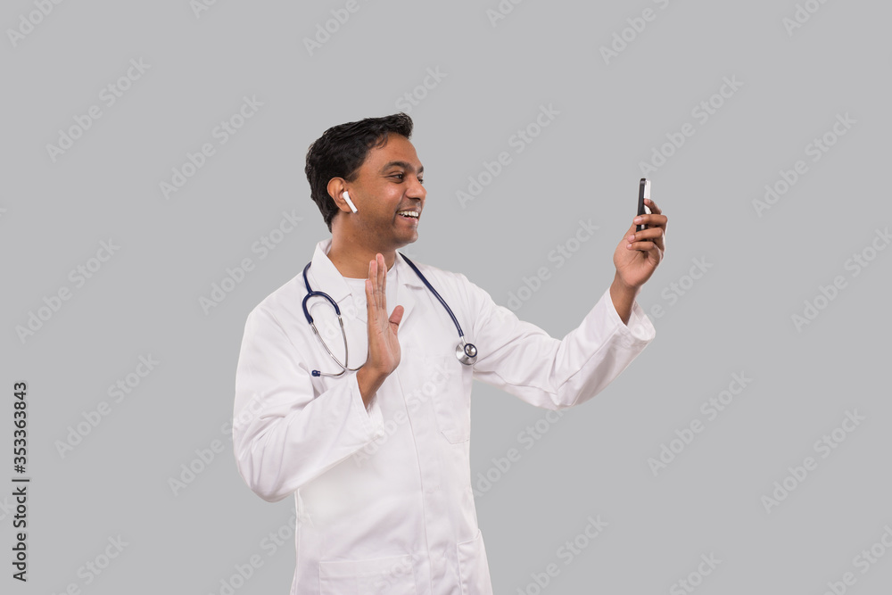 Doctor Having Video Call on Phone Wireless Earphones Isolated. Indian Man Doctor Video Call. Medicine Online. Doctor Using Phone. Doctor Having Video Call on Phone Wireless Earphones Isolated. Indian Man Doctor Video Call. Medicine Online. Doctor Using Phone.
