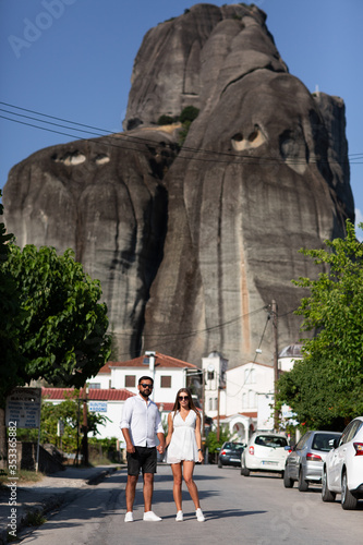 Beautiful couple on unique geological phenomenon of the landscape with huge vertical cliffs, on top of which are Orthodox monasteries .. The wonder of nature.