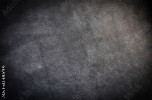 Dark gray cattle skin texture with empty place for text top view, background for your text. Flat lay