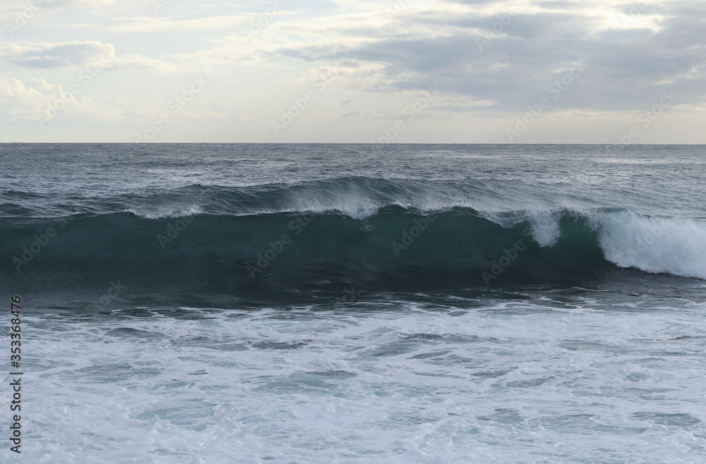 Close up of sea level while creating the perfect wave for surfers. The wave begins to flip and fall to the rest of the sea level. Stormy sea after a strong wind. Paphos, Cyprus Close up of sea level while creating the perfect wave for surfers. The wave begins to flip and fall to the rest of the sea level. Stormy sea after a strong wind. Paphos, Cyprus