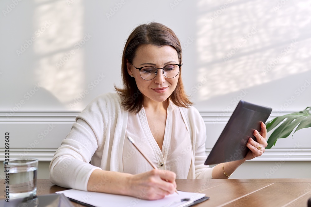 Woman teacher, mentor, psychologist looking at webcam of digital tablet Woman teacher, mentor, psychologist looking at webcam of digital tablet