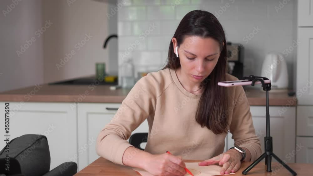 Millennial girl streaming her creative process on tablet. Online influencer. Millennial girl streaming her creative process on tablet. Online influencer.