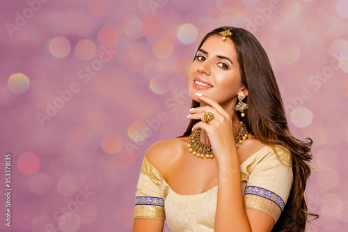 Fashionable Portrait of beautiful indian girl. beauty portrait. Young hindu woman model with kundan jewelry set. Close up. Traditional India costume lehenga choli or sari. make-up. 