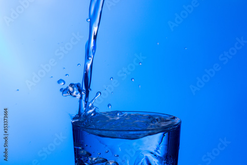 water falling into a clear glass