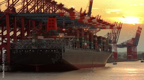 Container ship loading and unloading at sunset in the port of Hamburg / Germany
Wide angle shot, back light, slow zoom