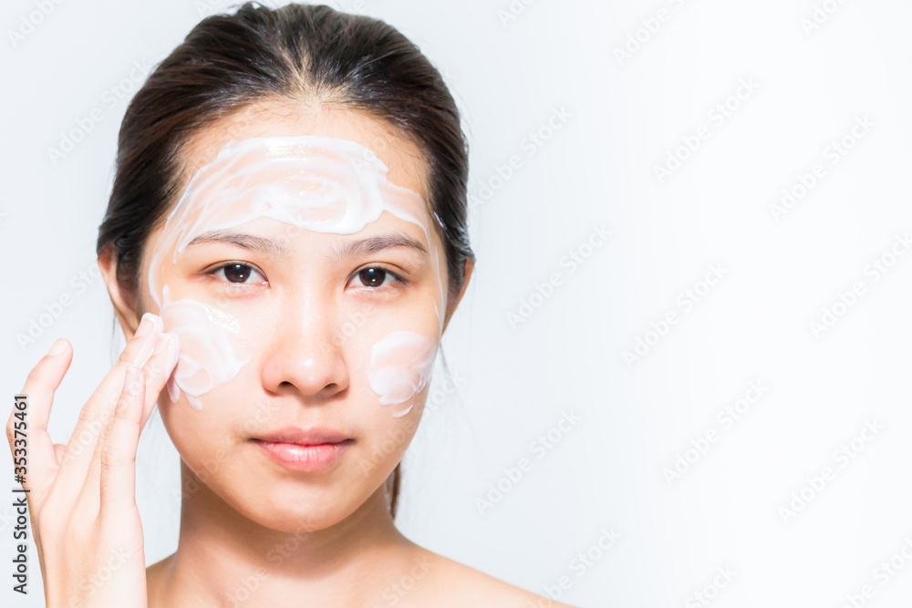 Young beautiful woman applying yogurt facial mask Skin care, beauty treatments on white background Young beautiful woman applying yogurt facial mask Skin care, beauty treatments on white background