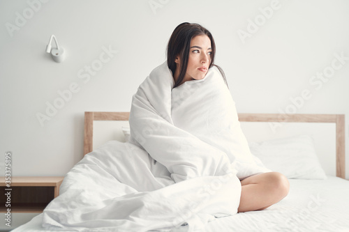 Low-spirited dark-haired Caucasian lady sitting in bed © Viacheslav Yakobchuk