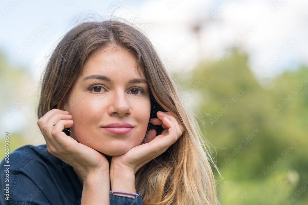 Portrait pensive of young woman outdoors