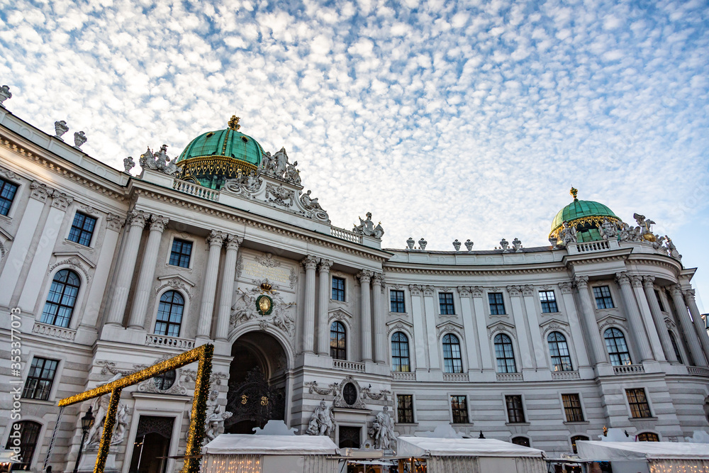 Green tops of the Hofburg Palace against the sky with pocked cirrocumulus clouds. Horizontal orientation. 